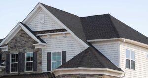 Asphalt shingle roofing on a multi-story family home